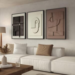 Three large minimalist abstract wall art pieces hanging above a white sofa in a modern interior.