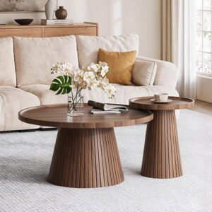 Pair of round dark wood fluted coffee tables in a stylish living room setting.