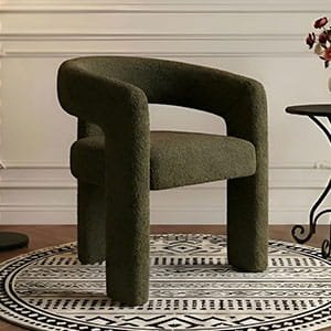 Stylish dark green textured armchair with a bold, architectural frame on a circular patterned rug