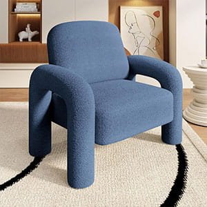 Contemporary chunky blue upholstered armchair with a unique rounded frame design on a neutral rug