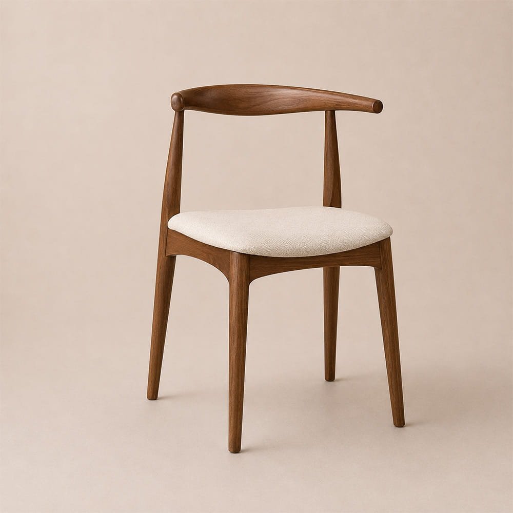 Minimal walnut wood dining chair featuring a curved backrest and soft cream upholstered seat.