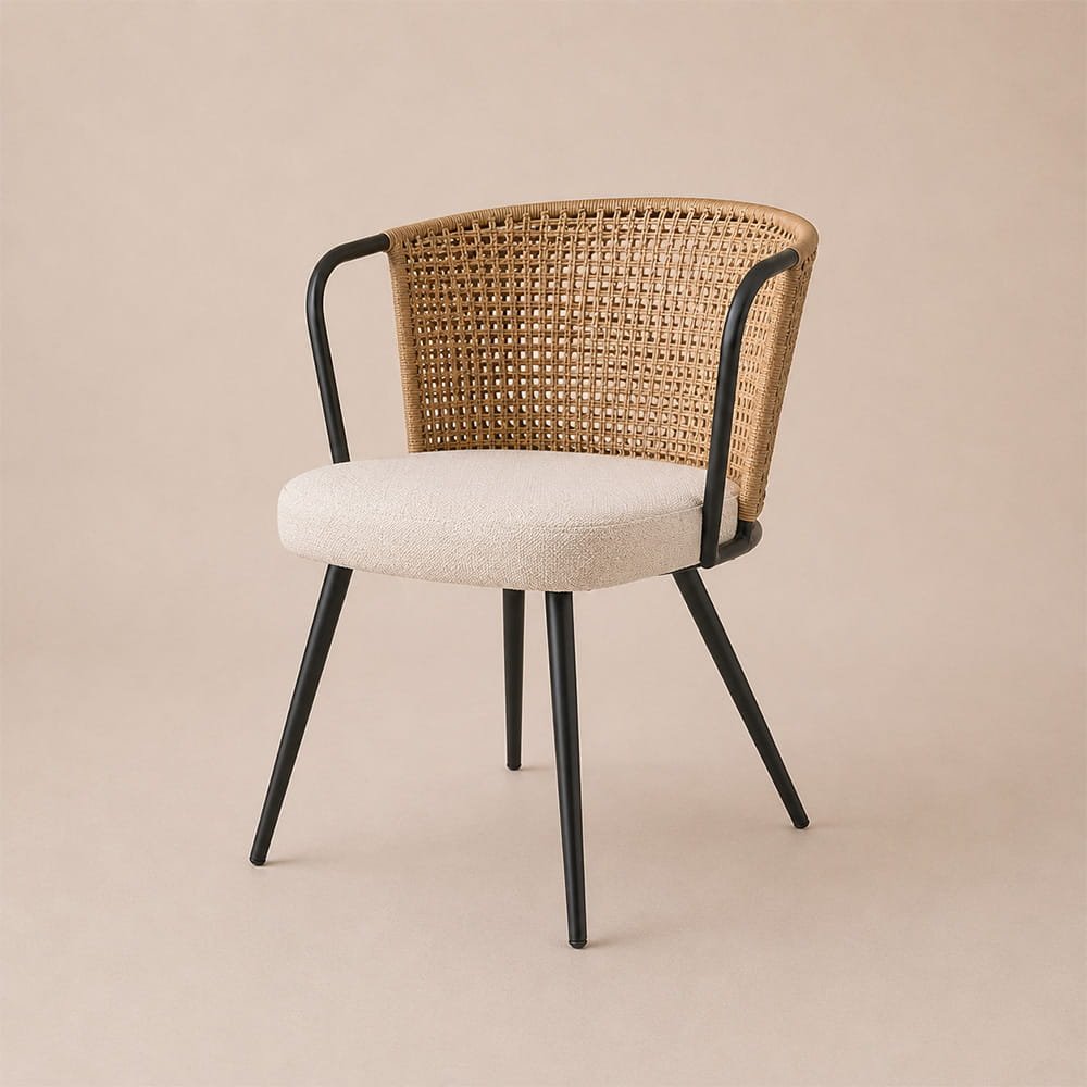Contemporary rattan dining chair with light cushion and sleek black metal legs in a minimalist studio setup.